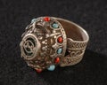 Vintage, fancy ring with precious, colorful stones isolated on a black background