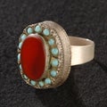 Vintage, fancy ring with precious red stone isolated on a black background