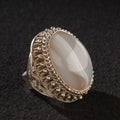 Vintage, fancy ring with precious white stone isolated on a black background