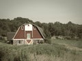 Vintage farm barn with gambrel roof in sepia tone