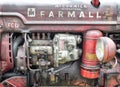 vintage farmall red tractor showing engine details and rust