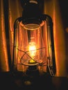 Vintage farmhouse lantern with light bulb illuminating.