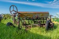 Vintage farming disc harrow in tall grass