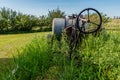 Vintage farming pull-type sprayer in tall grass