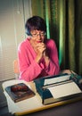 Vintage female writer reporter working behind his desk Royalty Free Stock Photo