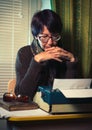 Vintage female writer reporter working behind his desk Royalty Free Stock Photo