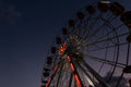 Vintage ferris wheel with lights at night lighting. Amusement park in Europe in the evening Royalty Free Stock Photo