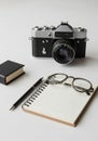 A vintage film camera with a black and silver design is centered in the background. In Royalty Free Stock Photo