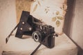 Vintage film camera with leather case on white background