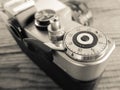 Vintage film camera made in URSS, lying over a dated wooden background