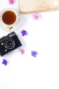 The vintage film camera, old book, flower and tea on white background . Royalty Free Stock Photo