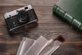 Vintage film camera, film and photo album on a dark wooden table. The view from the top. Old technology Royalty Free Stock Photo