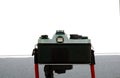 A vintage film camera on a tripod with black lens, retro and travel vintage concepts Royalty Free Stock Photo