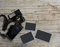 Vintage film camera and two blank photo frames on wooden table. Top view with copy space Royalty Free Stock Photo