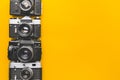 Vintage Film Cameras On Yellow Background Surface. Creativity Retro Technology Concept Royalty Free Stock Photo
