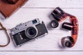 Vintage film rangefinder camera with leather case on white wooden table Royalty Free Stock Photo