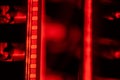 Vintage filmstrip in soft red light. Analog old strips of film for a photo or video camera close up. The concept of Royalty Free Stock Photo