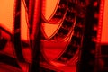 Vintage filmstrip in soft red light. Twisted analog old strips of film for a photo or video camera close up. The concept Royalty Free Stock Photo