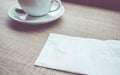 Vintage filter : Tissue paper with coffee stain on wood table Royalty Free Stock Photo