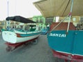 Marsaxlokk, Malta, August 2019. Multi-colored boats on the concrete promenade.