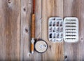 Vintage fishing fly equipment and lure container on rustic woode Royalty Free Stock Photo