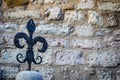 Vintage fleur-de-lys made of cast iron, Gubbio, the background, Umbria, Italy