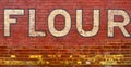 Vintage Flour bakery sign on the side of an old building