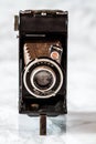 Vintage Folding Camera on Marble Background Royalty Free Stock Photo