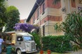 Vintage food truck under purple Wisteria climbing plant in a municipial park