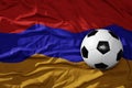 Vintage football ball on the waveing national flag of armenia background. 3D illustration