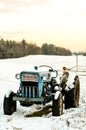 A vintage Ford tractor in the snow
