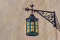 Vintage forged street lamp on wall.