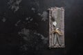 Vintage fork and knife on dark stone rustic background. Top view, copy space. Royalty Free Stock Photo