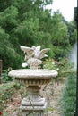 Vintage fountain. Beautiful vintage fountain in a garden with lo