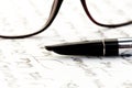 Vintage fountain pen on a letter, glasses behind Royalty Free Stock Photo