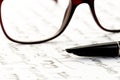 Vintage fountain pen on a letter, glasses behind Royalty Free Stock Photo