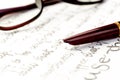 Vintage fountain pen on a letter, glasses behind Royalty Free Stock Photo