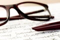 Vintage fountain pen on a letter, glasses behind Royalty Free Stock Photo