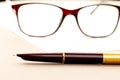 Vintage fountain pen on a letter, glasses behind Royalty Free Stock Photo