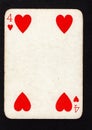 A vintage four of hearts playing card on a black background.