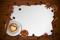 Vintage frame with cup of coffee, spices, and biscuit on wooden table