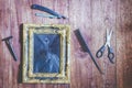 Vintage frame and hairdressing tools on wooden background Royalty Free Stock Photo