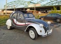 Vintage French popular car Citroen 2CV and old steel bridge Royalty Free Stock Photo