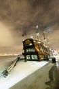 Vintage frigate on the Neva river in Saint Petersburg, Russia. Big ship sailing boat in winter frosty night.