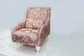 Vintage furniture: reclining chair made of fabric, on a light background.
