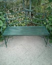 Vintage garden bench among flowers and greenery