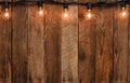 Vintage garland string lights on old wooden wall Royalty Free Stock Photo