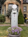 Old Gas Pump with Flower Arrangement in Front of Toronto Home