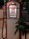 Vintage gas pump near a palm tree