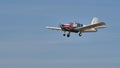 Vintage general aviation private airplane in flight in blue sky. Copy space.